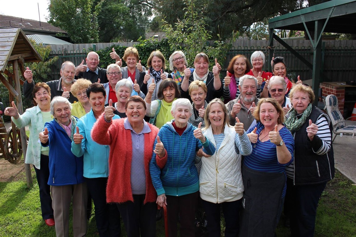 Whittlesea community house participants gather around for a happy photo