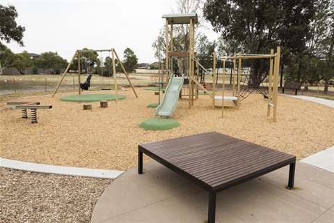 Playground with slide, swings and seating