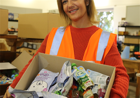 A woman holding a box of baby food