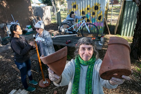 Hands-on crafting and restoration project in a community garden setting.