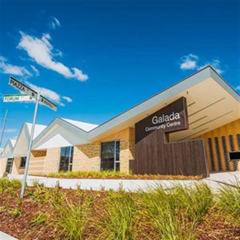 Wide-angle photo of Galada Community Centre exterior with blue sky above..